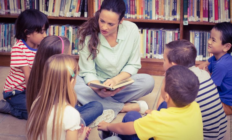 teacher sitting with class